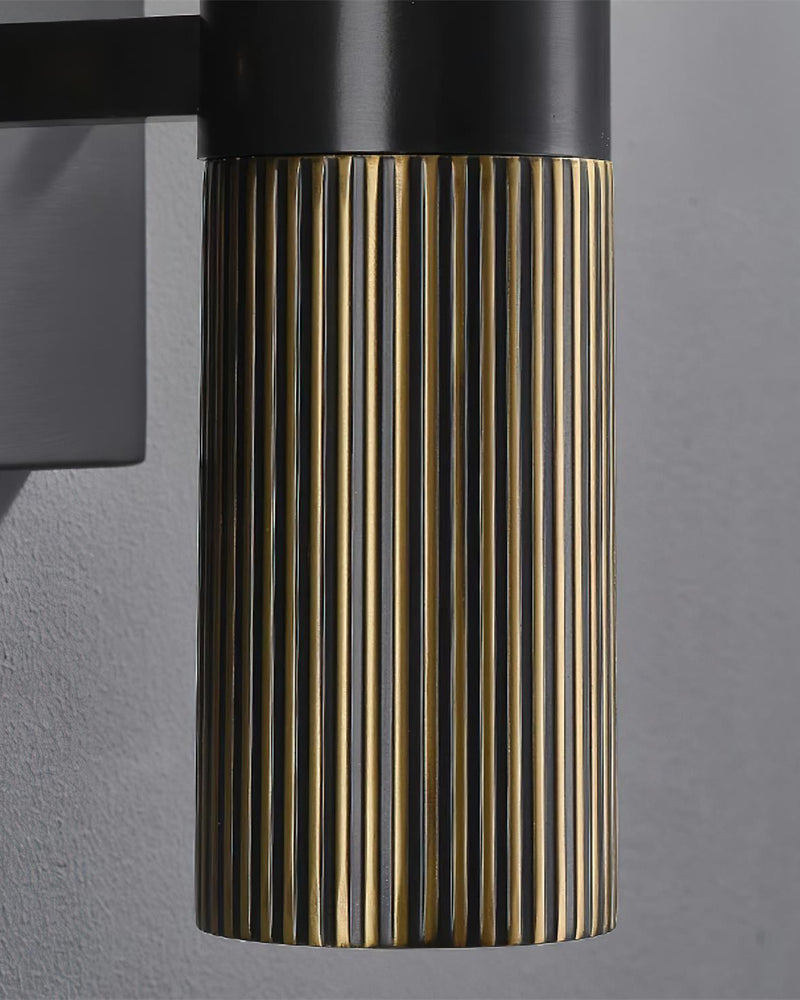 Close-up of the fluted brass base and black arm bracket of the ALABA No.07 alabaster wall sconce