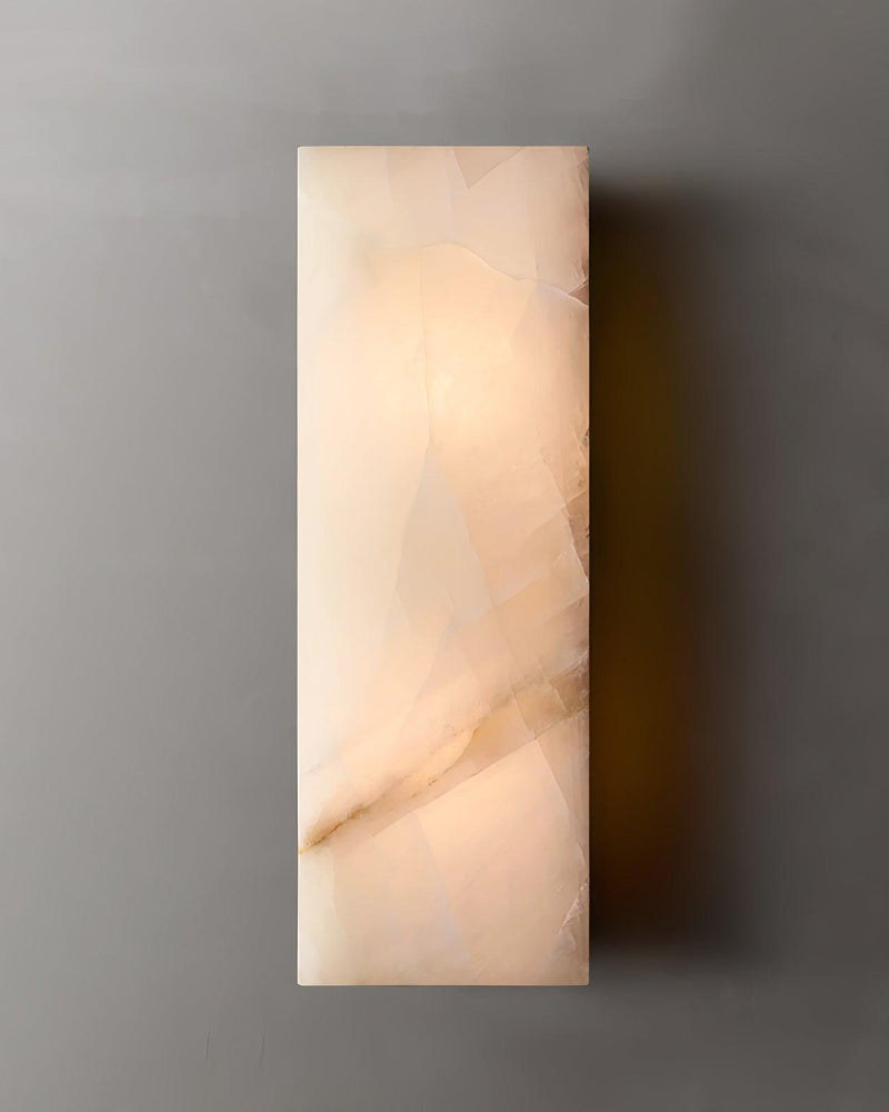Alabaster wall sconce ALABA No.03, tall monolithic alabaster panel lit against a white wall
