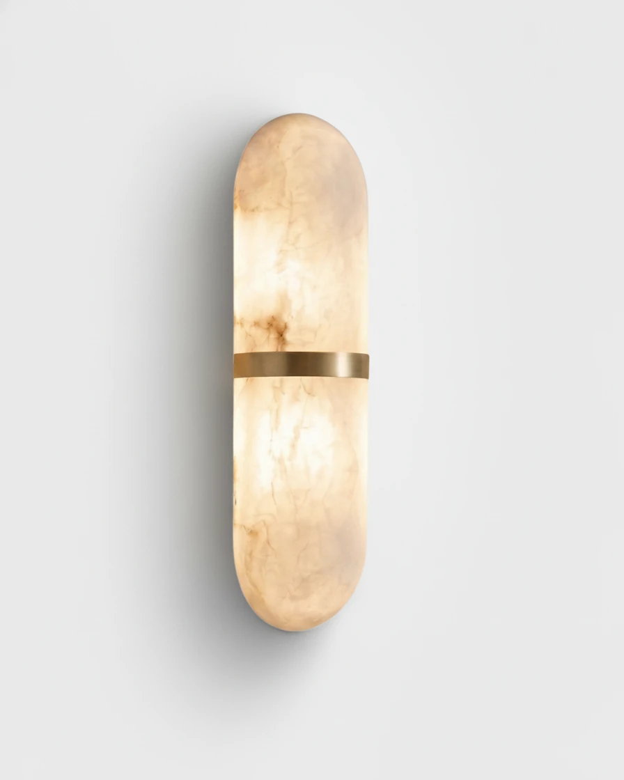 Alabaster wall sconce OLIVA No.01 in Brass Band, veined alabaster capsule glowing with a brass center band