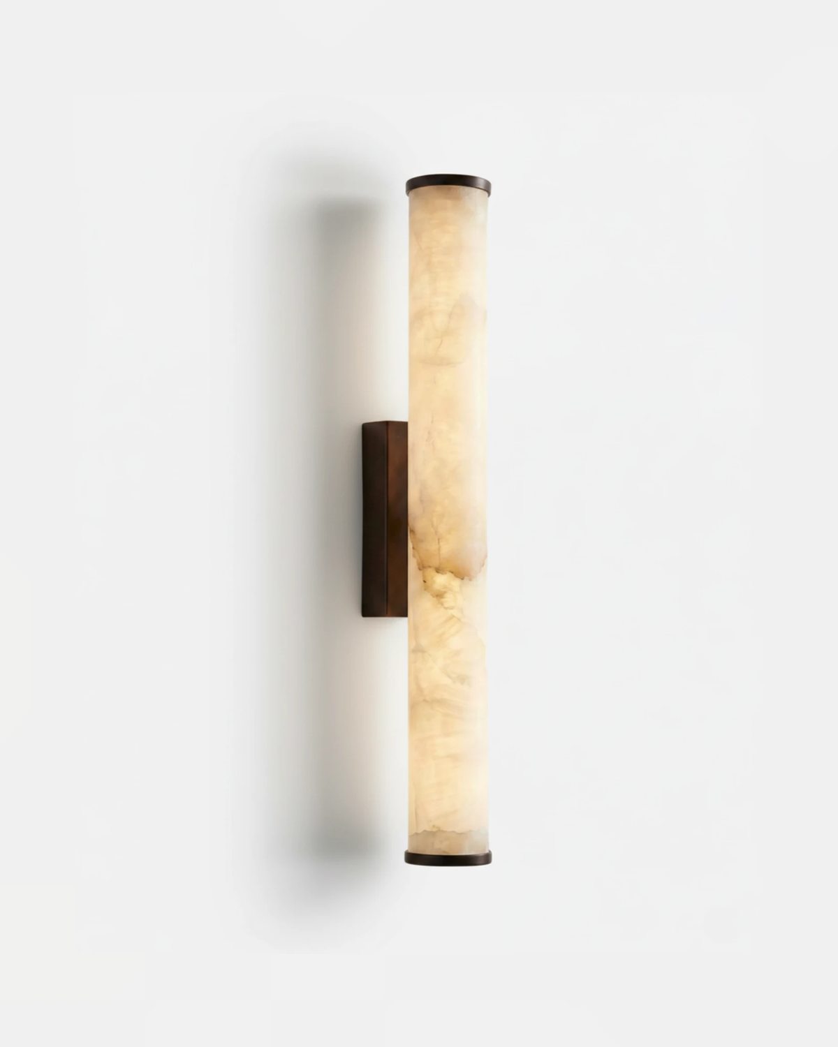 Alabaster wall sconce NEBBIA No.01, 20 in tube on a Dark Bronze bracket, switched on, front view on white