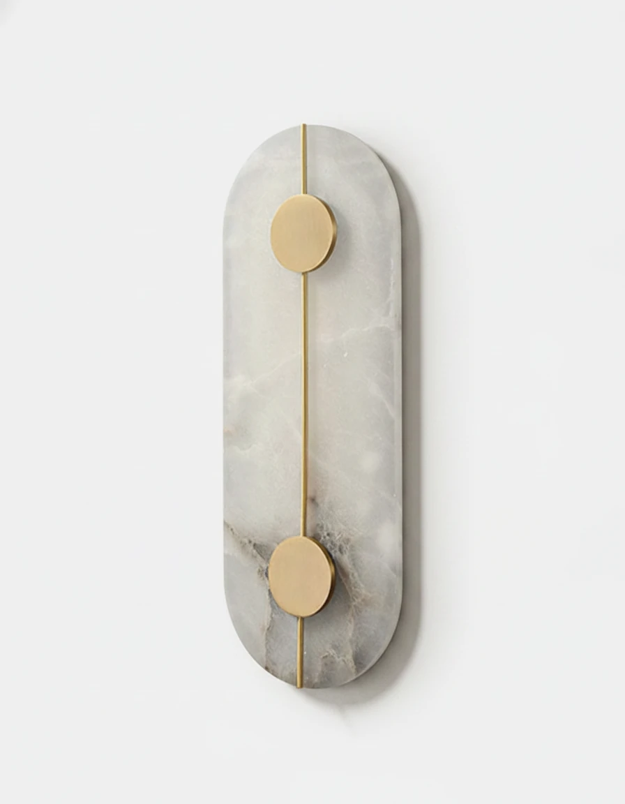 Alabaster wall sconce OLIVA No.03 Oval, tall alabaster pill shape with two brass discs on a vertical brass line, unlit