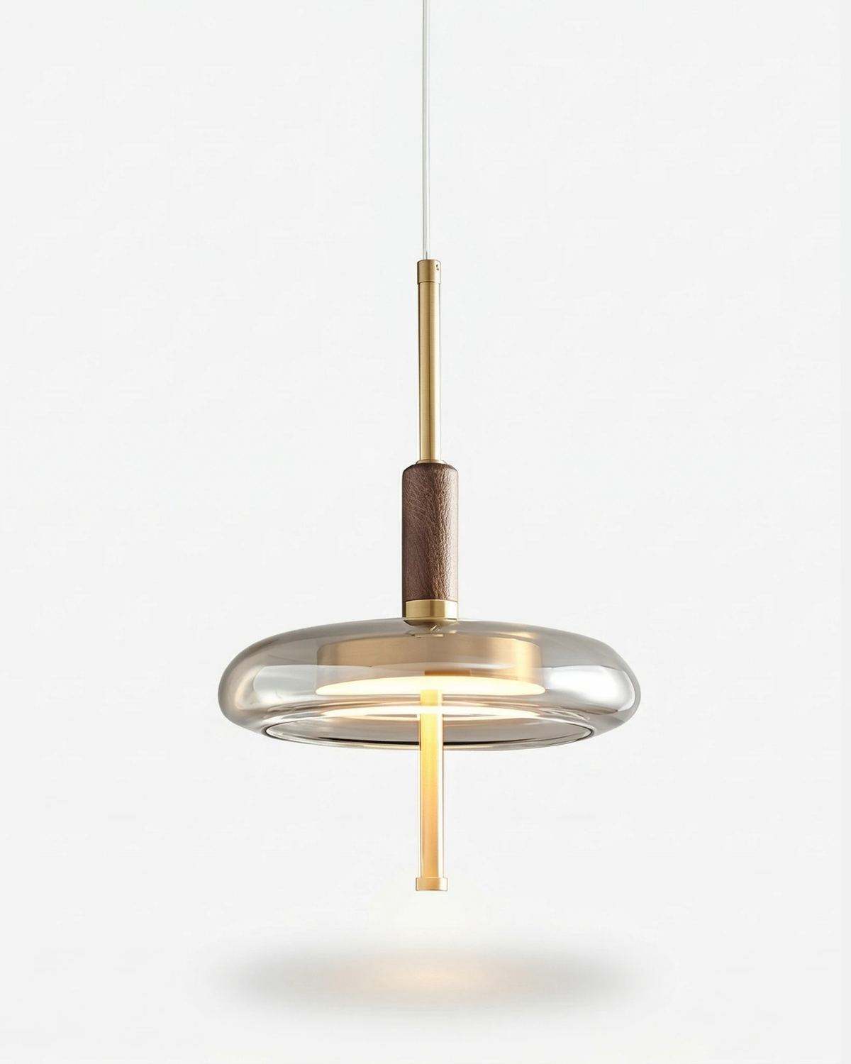 Amber glass pendant light NOCE No.01, smoked glass disc with walnut stem and brass rod, switched on