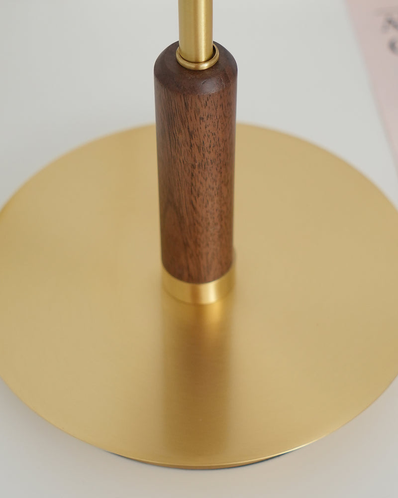 Close-up from above of the amber glass table lamp TARO No.02 base, walnut grip and slim brass rod