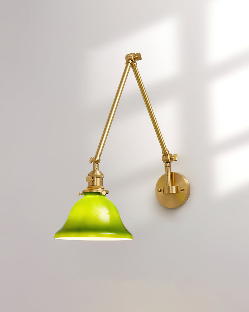 Brass wall sconce DALIA No.04, extending arm folded upward with the emerald bell lit