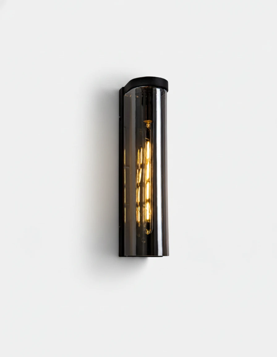 Brass wall sconce PILA No.01 Single Column in smoked glass with matte black iron frame, filament bulb lit