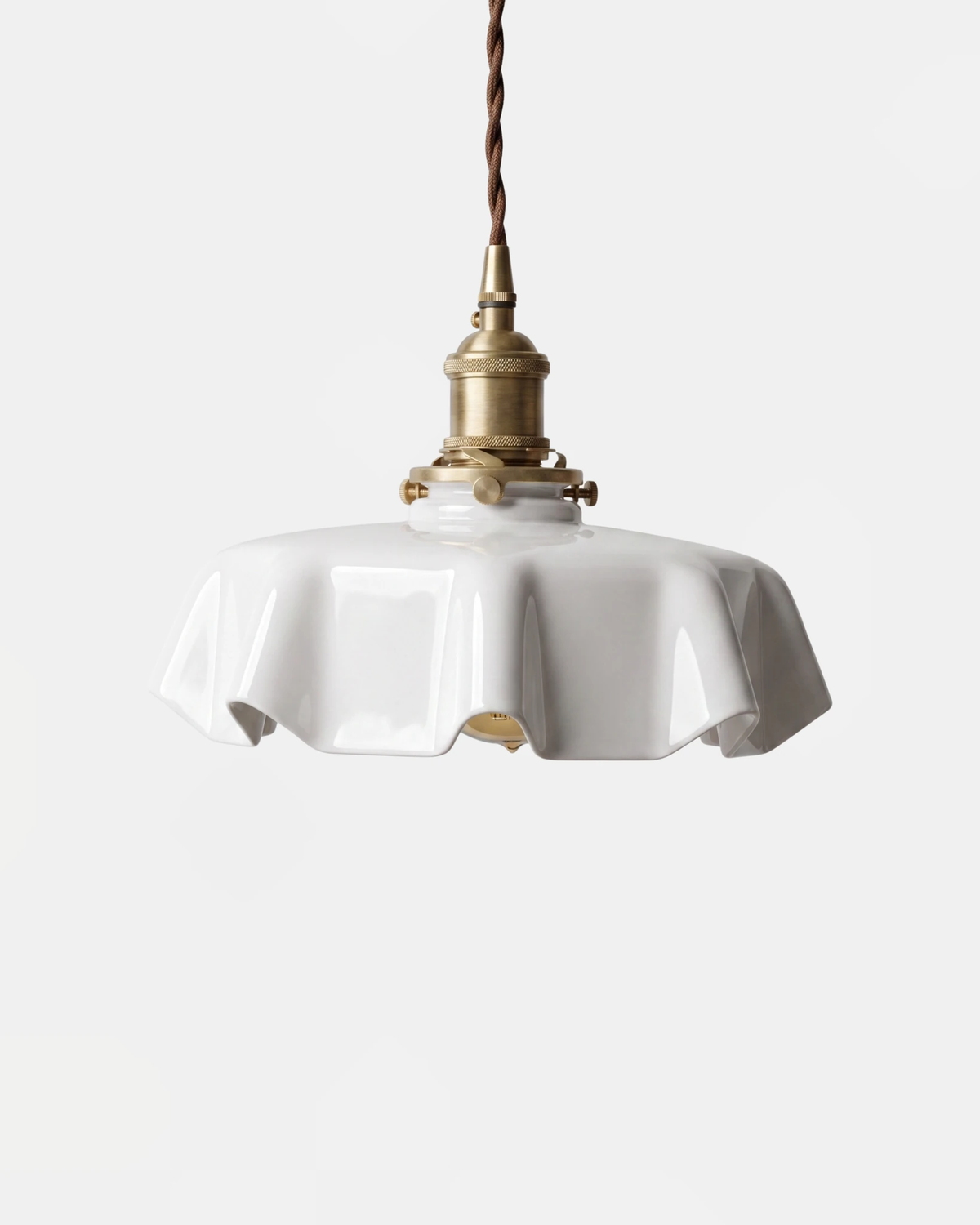 Ceramic pendant light CORA No.01 in bone white, scalloped porcelain shade on a brass socket and twisted cord
