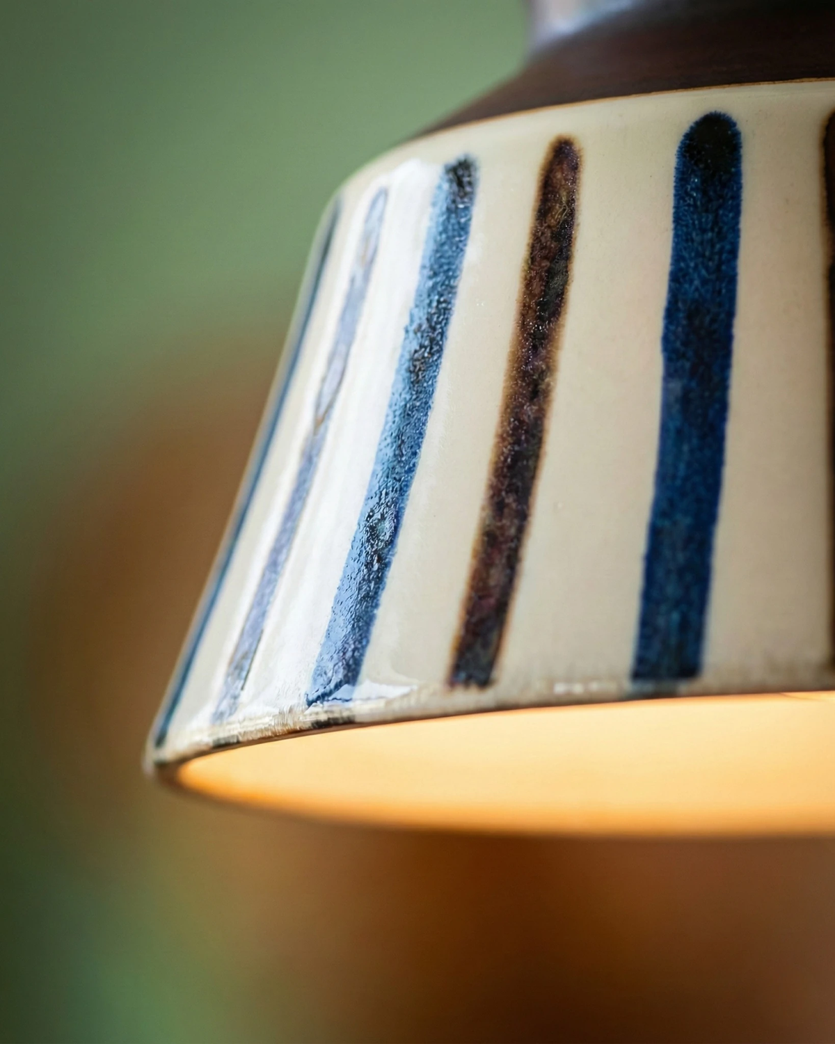 Close-up of the thin hand-painted stripes on the glazed bell of the MELI No.05 ceramic pendant light