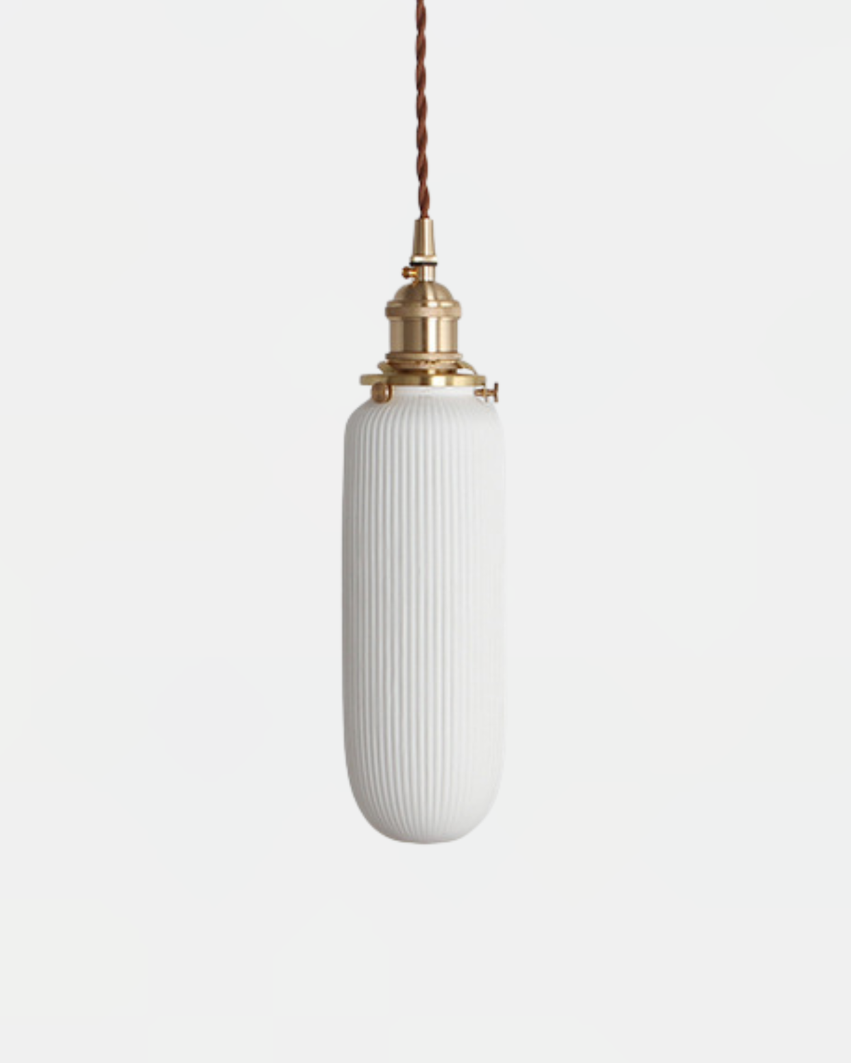 Ceramic pendant light SERA No.01 Fluted Flask, tall slim ribbed white ceramic shade hung from a brass fitting