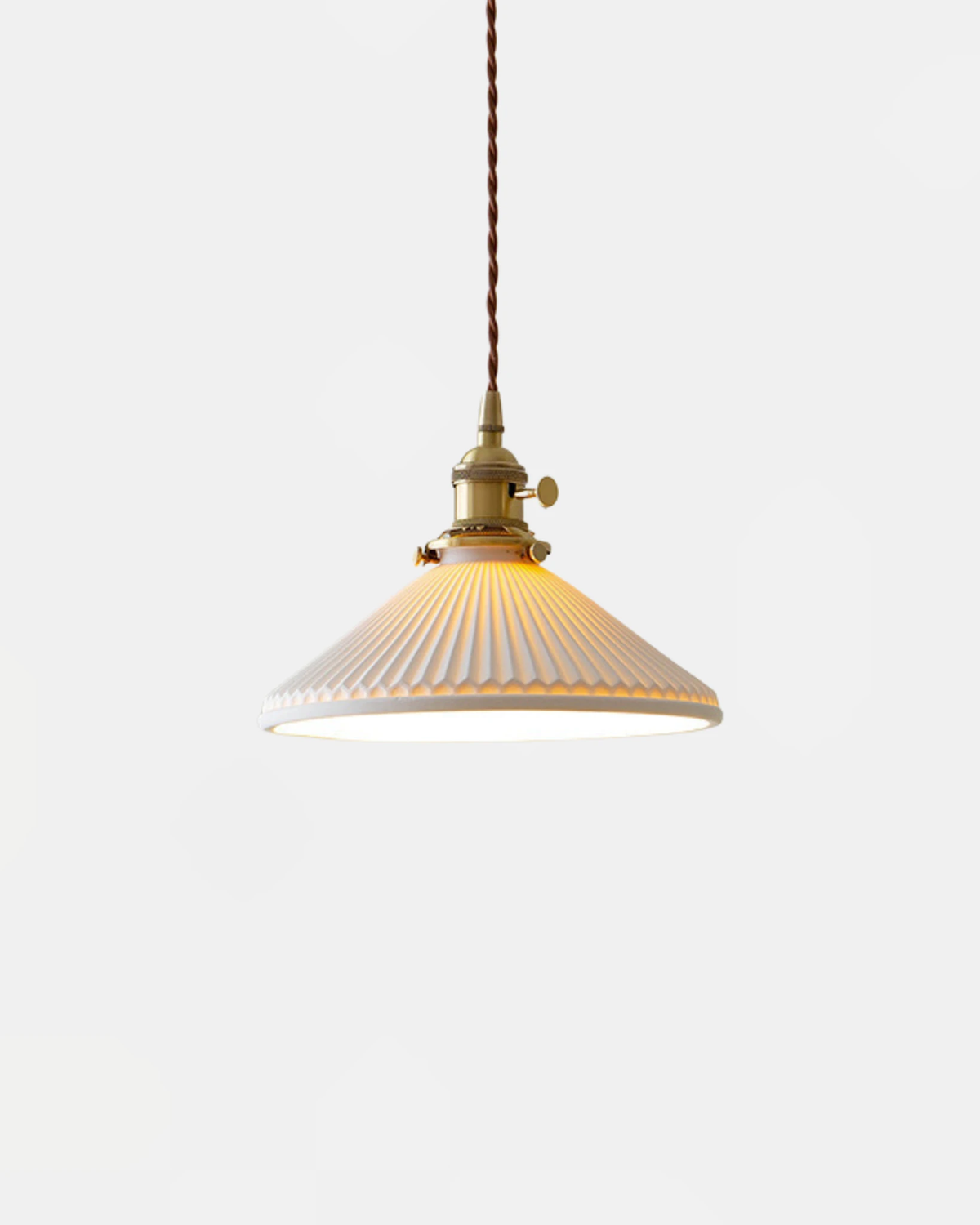 Ceramic pendant light CORA No.02, pleated cream porcelain cone with brass fitting and twisted cord, lit