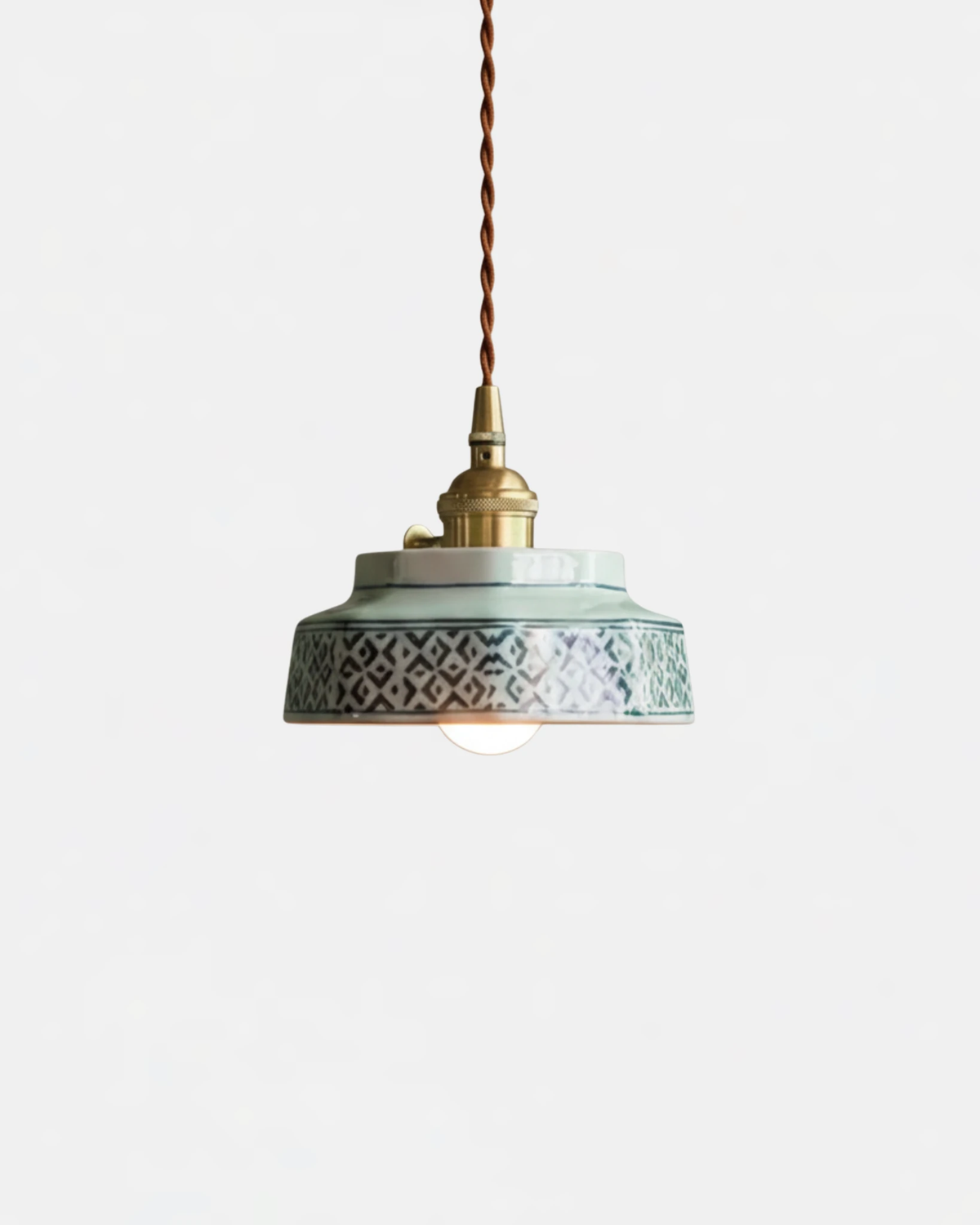 Ceramic pendant light RAGUSA No.02 in Jade Geometric, painted diamond pattern shade with brass collar and twisted cord, lit