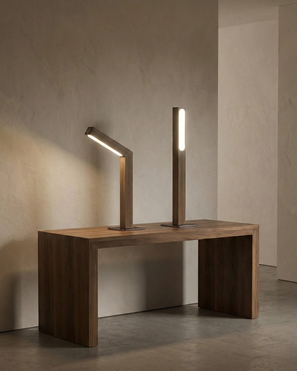 Cordless desk lamp RAMO No.01, two wooden lamps lit on a walnut bench in an empty plaster room