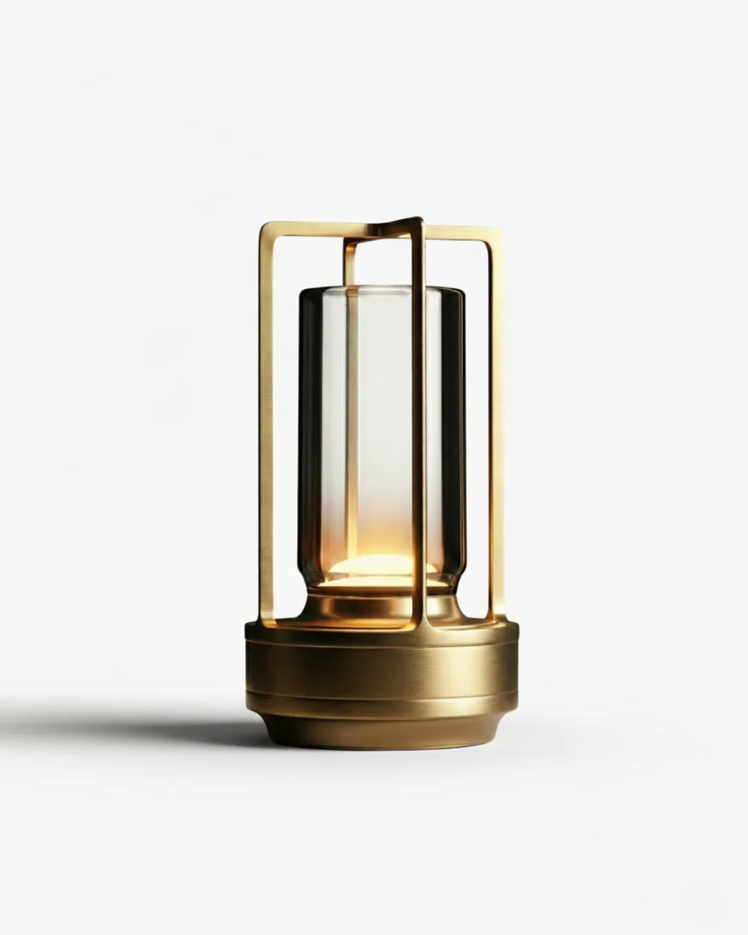 Cordless lantern lamp LATTA No.01 in Brushed Gold, glass cylinder glowing in a gold aluminum frame