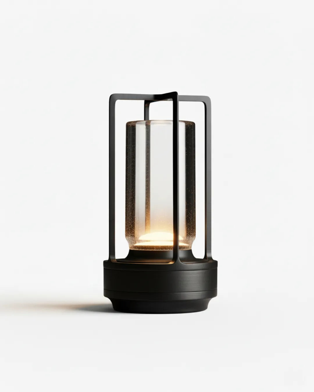 Cordless lantern lamp LATTA No.01 in Matte Black, lit glass cylinder with a black frame and base
