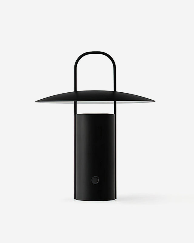 Cordless lantern lamp PORTO No.01 in Volcano Black, disc shade and arched handle, switched on, white background