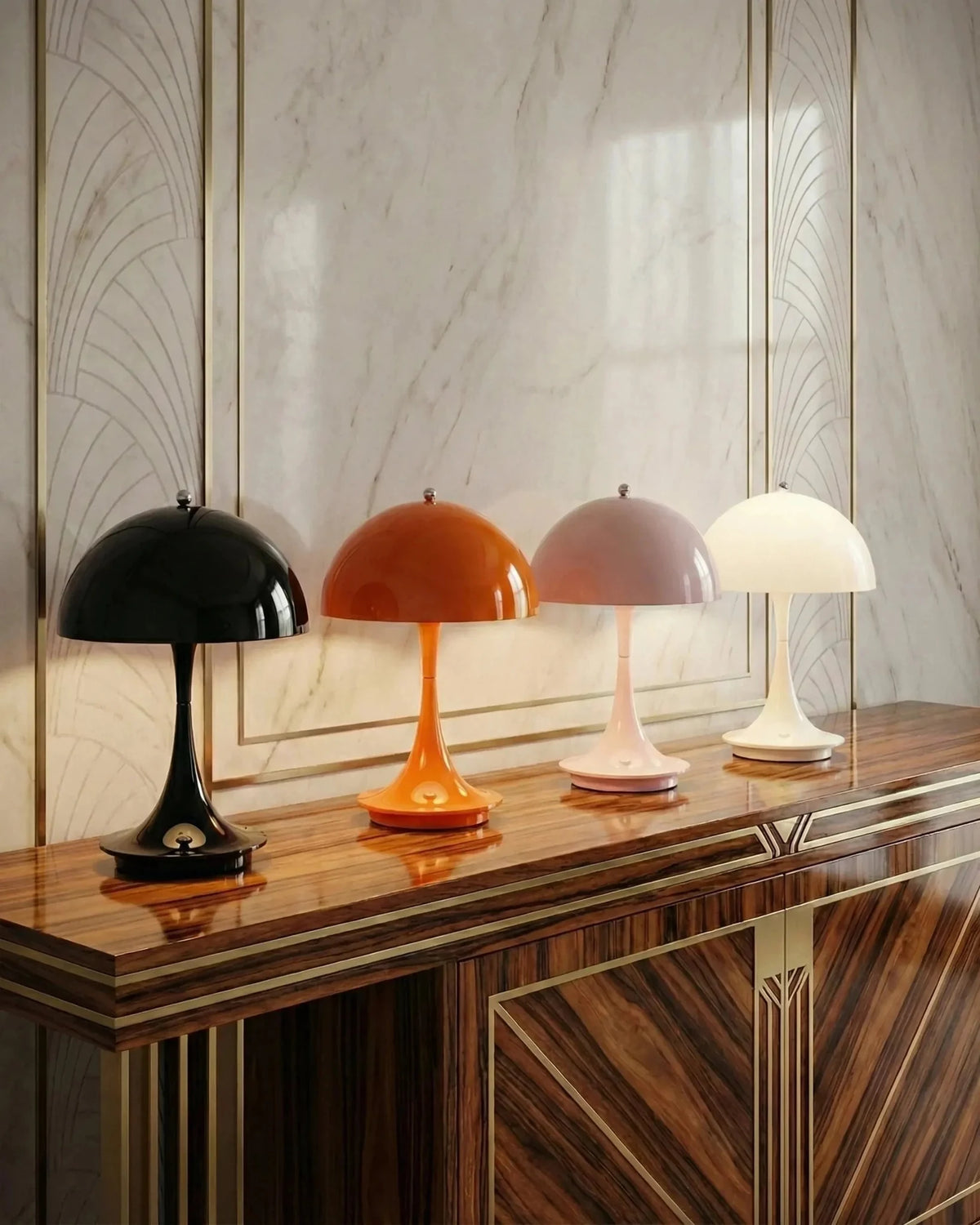 Four cordless mushroom lamps FONTE No.01 in black, orange, pink and white lit on a wooden sideboard