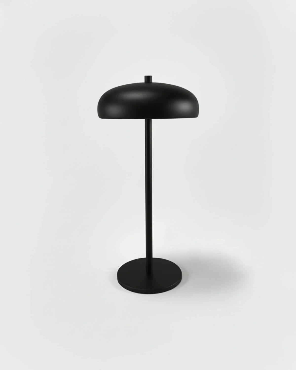 Cordless mushroom lamp DOMA No.01 in Volcano Black, matte black dome shade and stem on a disc base, unlit