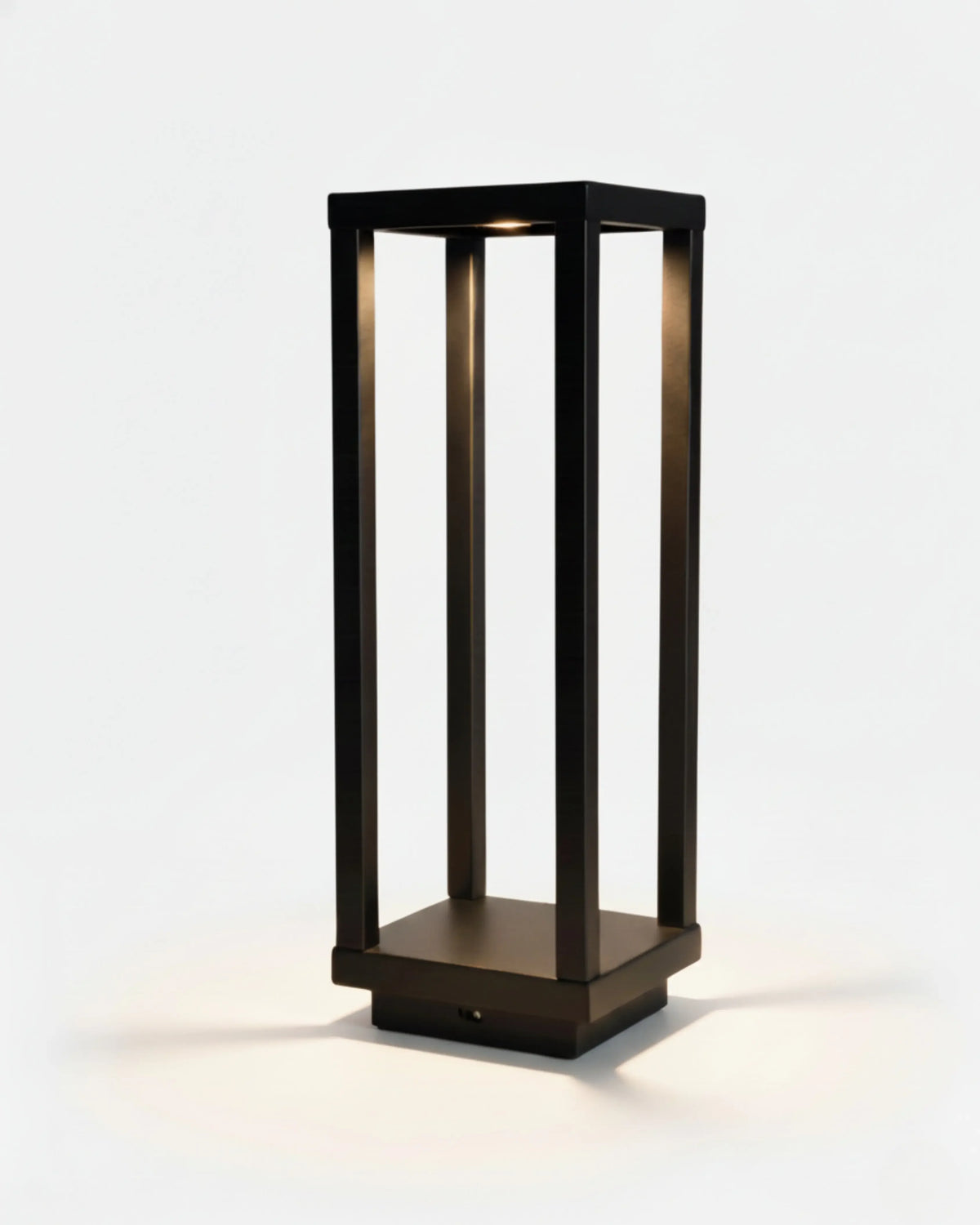 Cordless outdoor table lamp FARO No.07 in Matte Black, tall rectangular aluminum lantern frame switched on