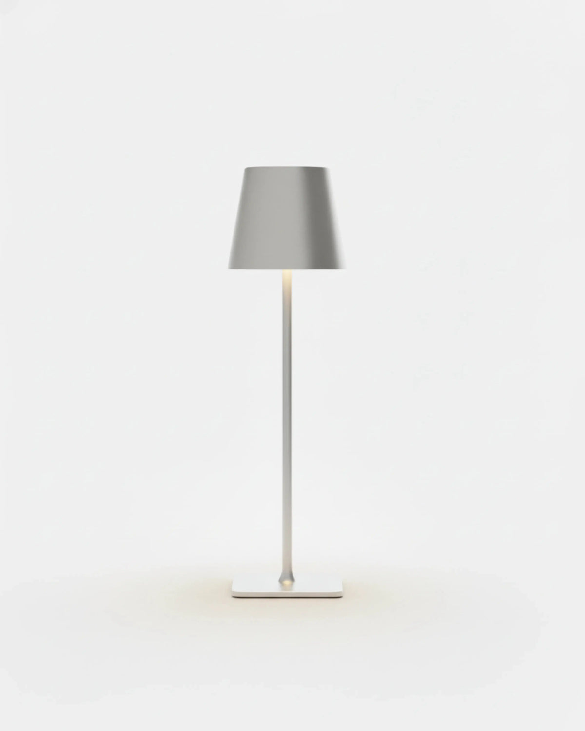 Cordless table lamp FOGGIA No.01 in Brushed Silver, metallic cone shade glowing above a slender stem