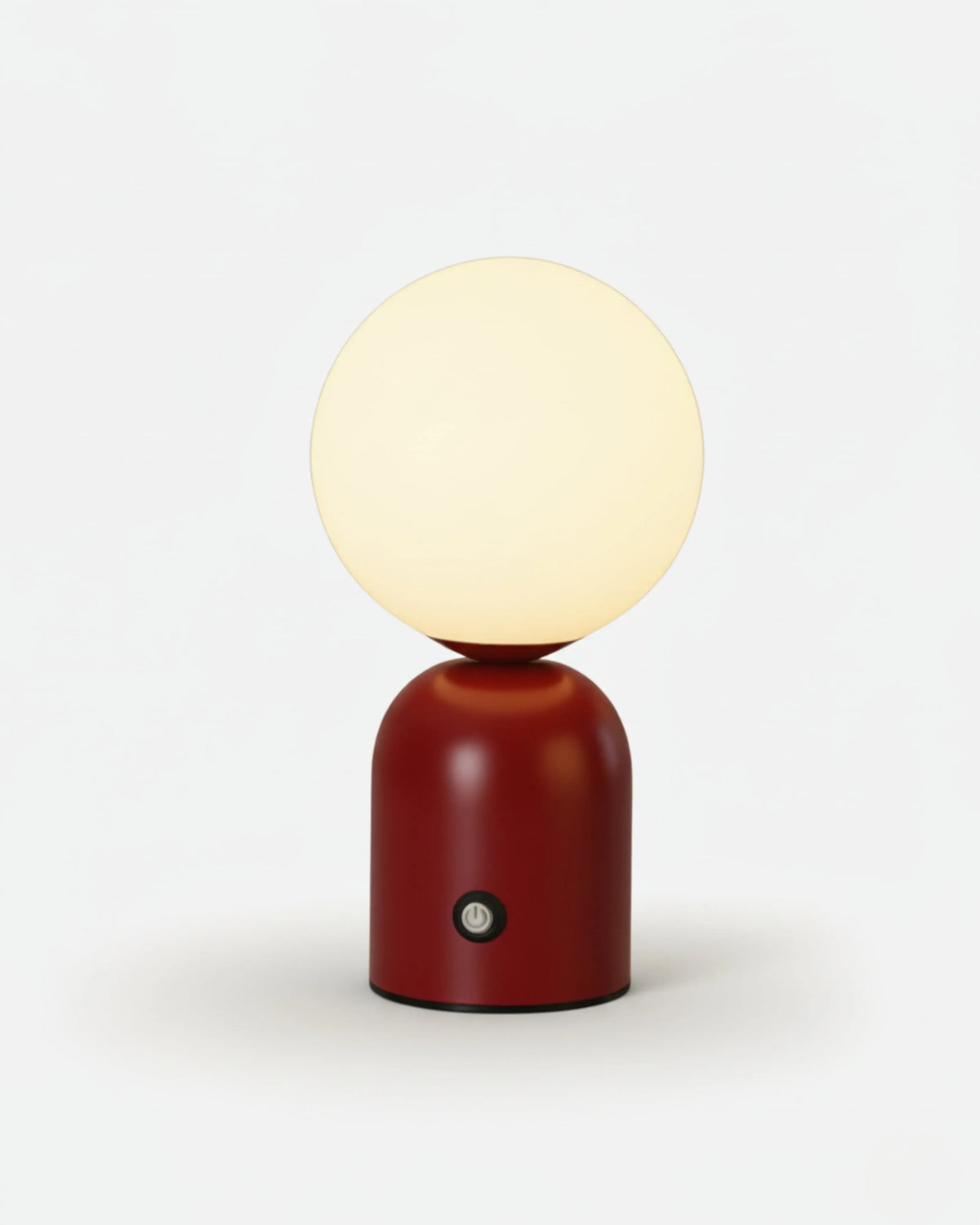 Cordless table lamp VIVA No.01 in Crimson Red, lit frosted globe atop a glossy red dome base