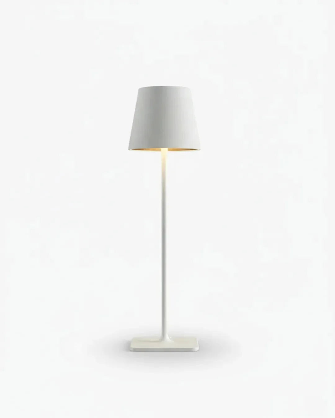 Cordless table lamp FOGGIA No.01 in Pure White, cone shade and thin stem lit on a white background