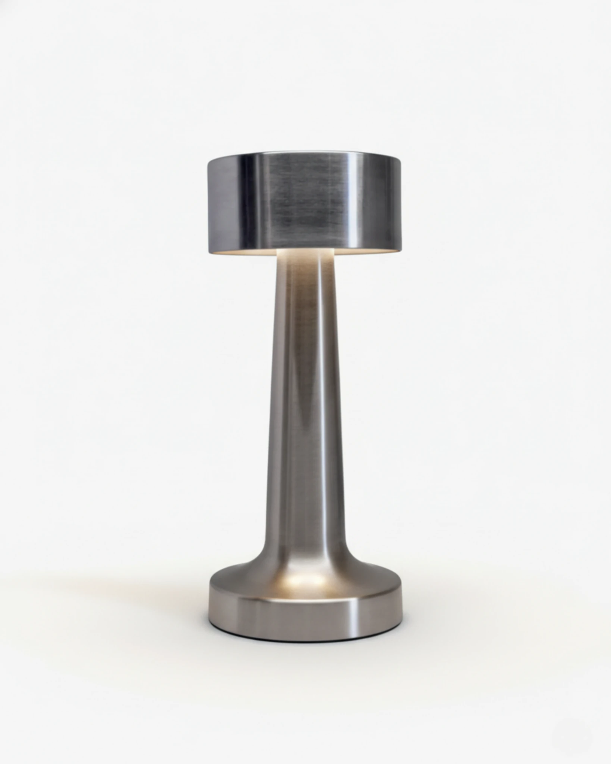 Cordless table lamp ISOLA No.01 in silver, dumbbell shape with a flat head glowing underneath