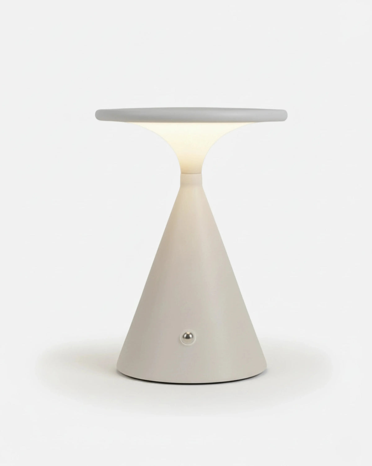 Cordless table lamp SOSTA No.01 in Warm White, tapered cone body under a lit disc plate, white background