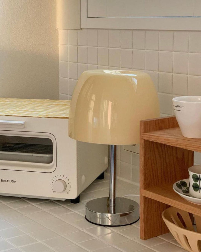Glass table lamp VENEZIA No.01 with cream shade on a wooden kitchen shelf beside a white toaster oven