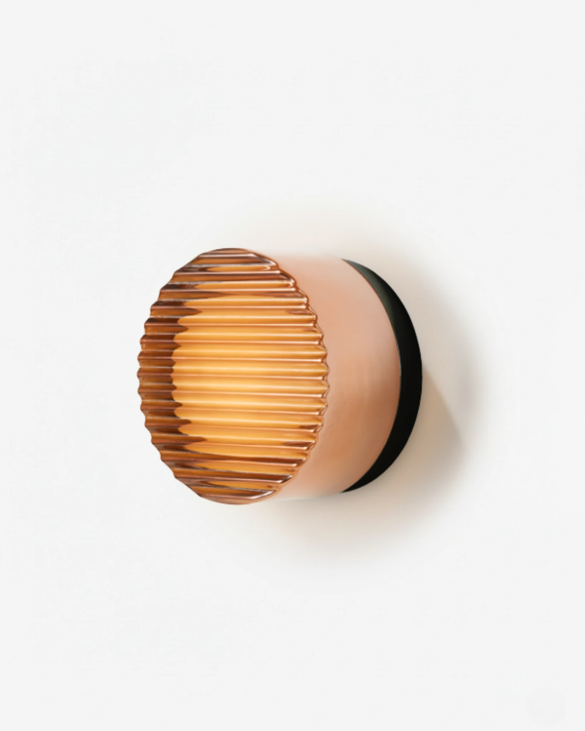 Glass wall sconce HALO No.08 in Amber Fluted, ribbed amber glass on a black base, lit