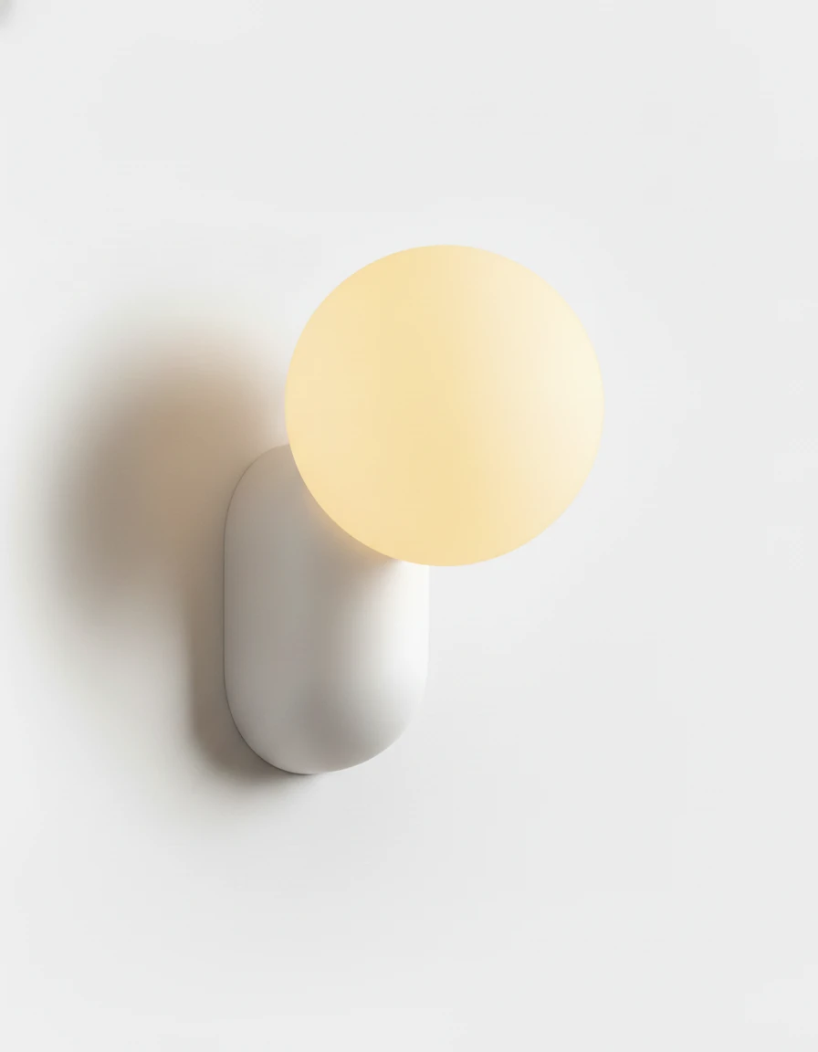 Globe wall sconce AURA No.04 in Cream White, lit opal globe on a smooth white resin capsule body