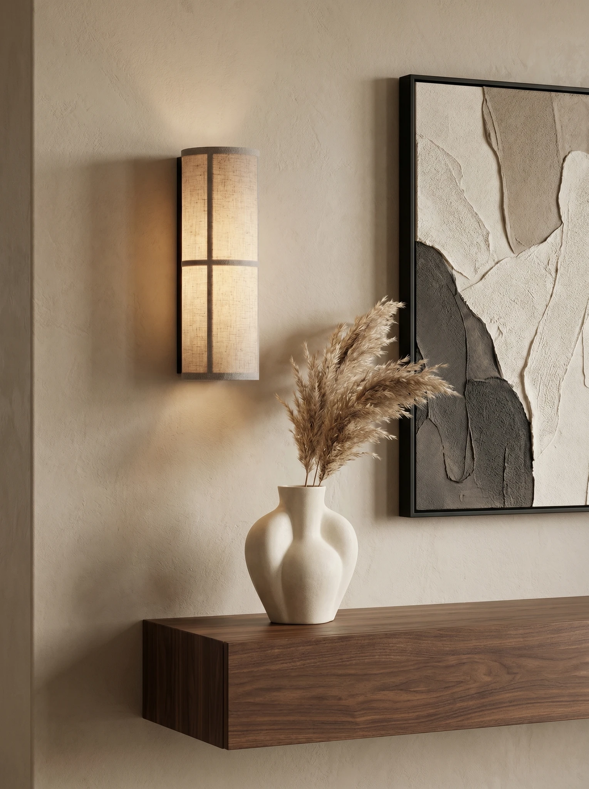 Linen shade wall sconce FUMO No.01 lit beside an abstract painting above a floating walnut shelf with a vase