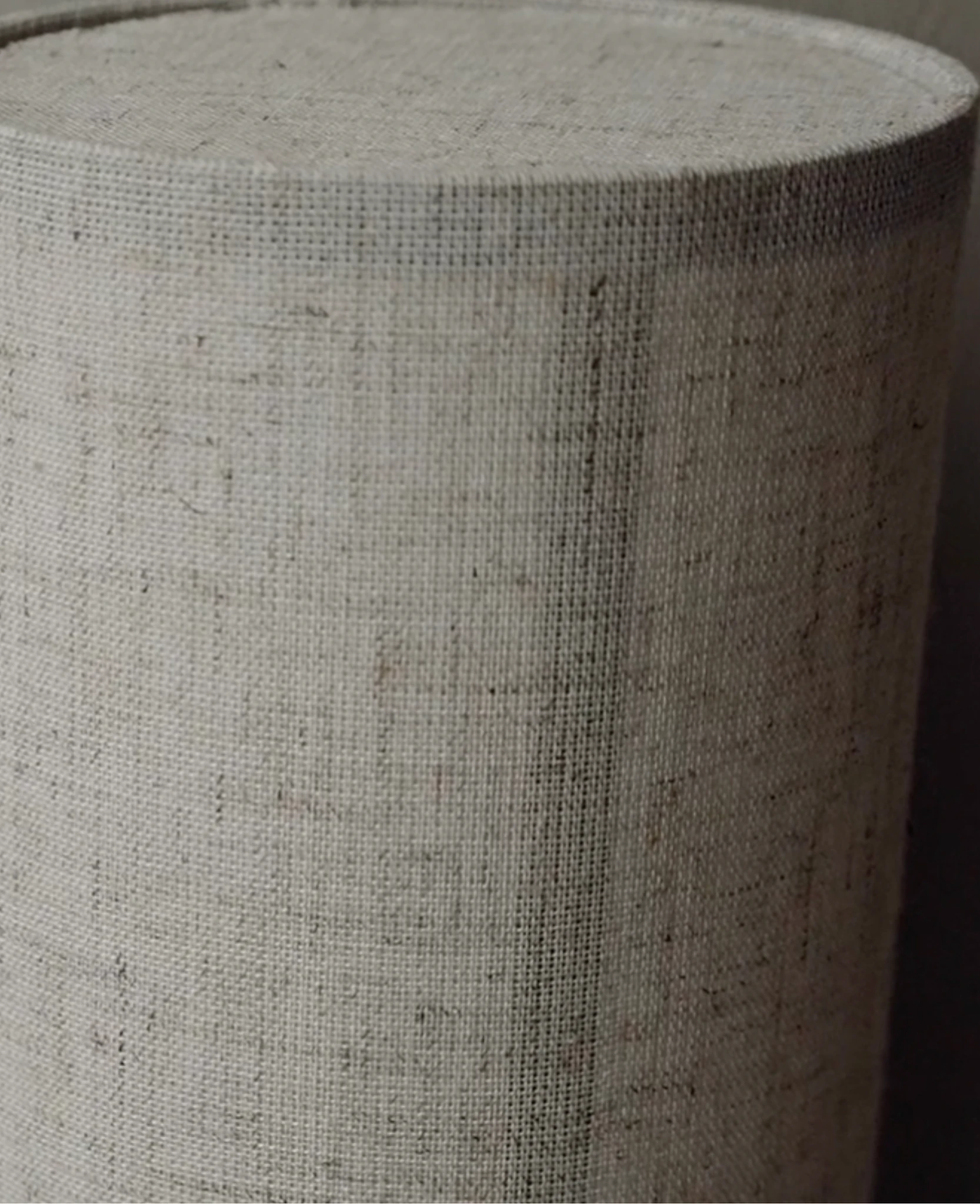 Close-up of the woven natural linen texture of the linen shade wall sconce FUMO No.01