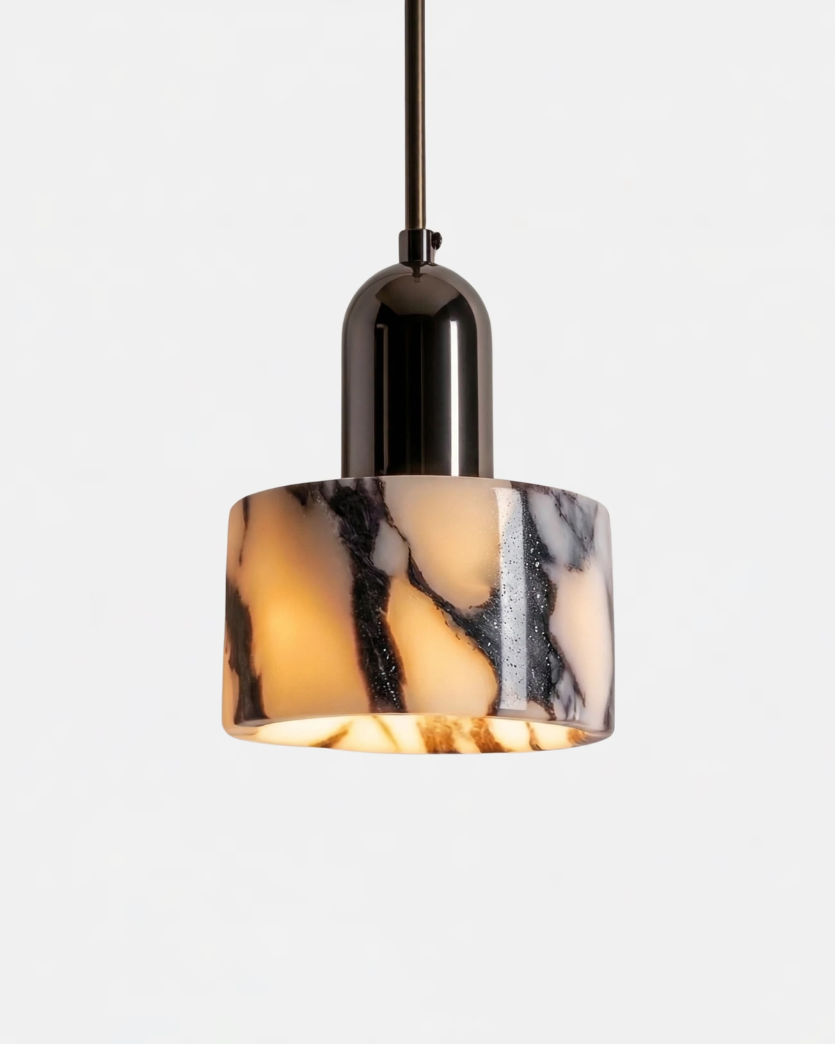 Marble pendant light MARMI No.02, veined marble cylinder glowing under a black chrome cap on a black cord