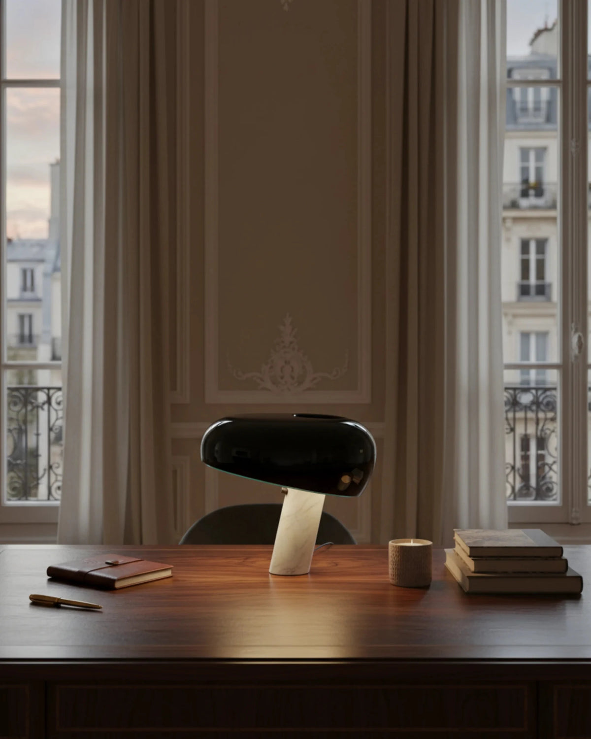 Marble table lamp BRUNO No.01 in black on a dark wood desk in front of tall windows with paneled walls and a city view