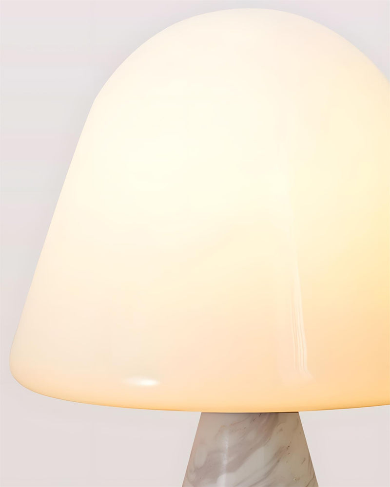 Close-up of the lit opal glass dome meeting the white marble base of the marble table lamp OLIVA No.04