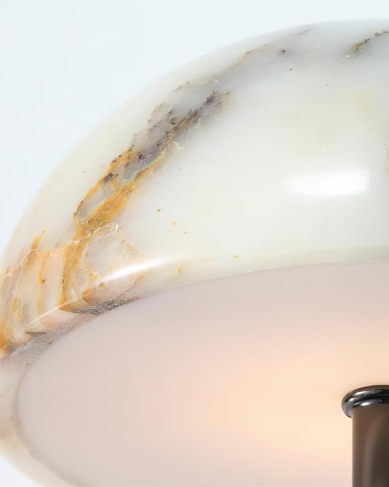 Close-up of the marble wall sconce NUVOLA No.01 dome edge with the underside glowing when lit