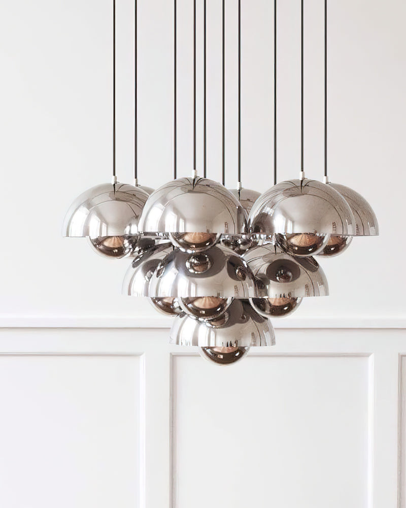 Modern chandelier FLORA No.01 with chrome mirror petal globes clustered near a white paneled wall