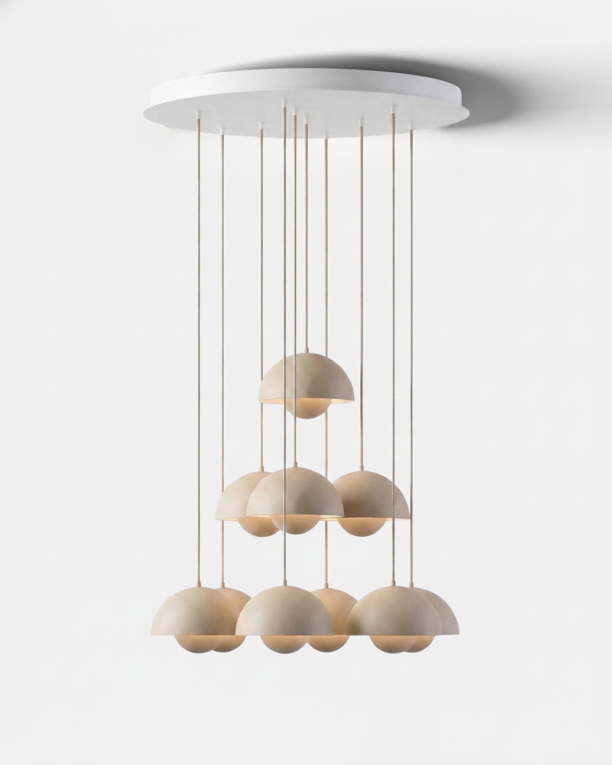 Modern chandelier FLORA No.01 Sonata, cream matte petal globes arranged in a stepped cascade on a white canopy