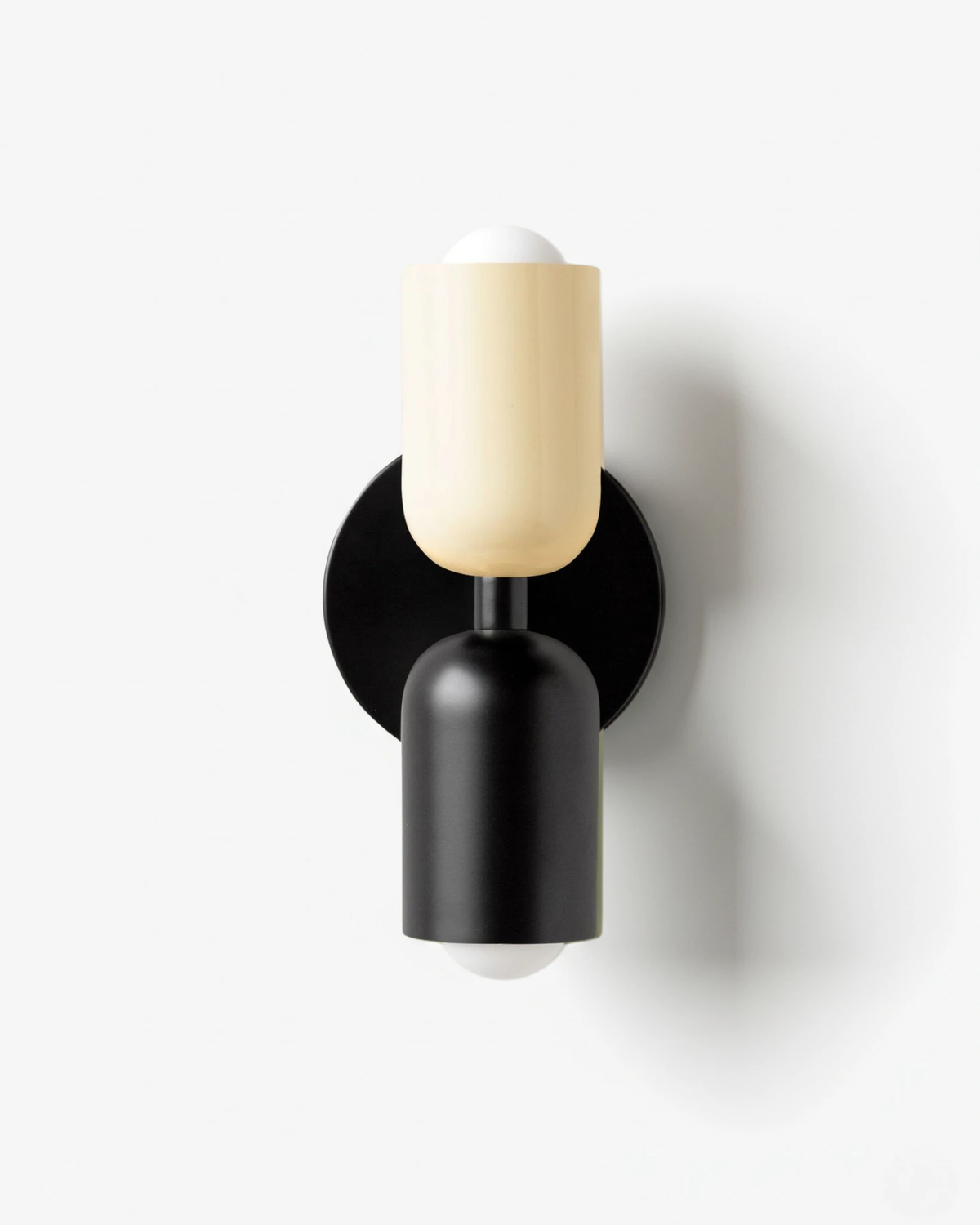 Modern wall sconce TORINO No.01 in Beige & Black, cream capsule over a black capsule on a matte black bracket
