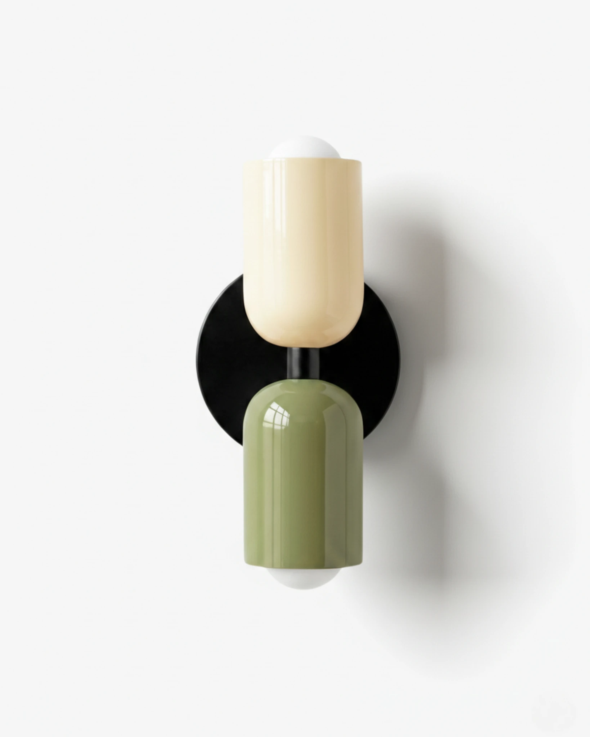 Modern wall sconce TORINO No.01 in Beige & Green, glossy capsule shades on a black iron backplate, unlit