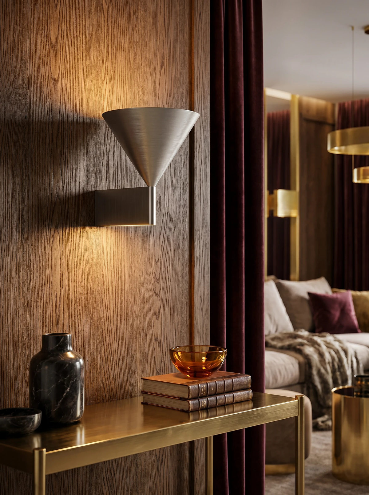 Modern wall sconce ETNA No.01 in aluminum lit on an oak wall above a brass console with books and a bowl