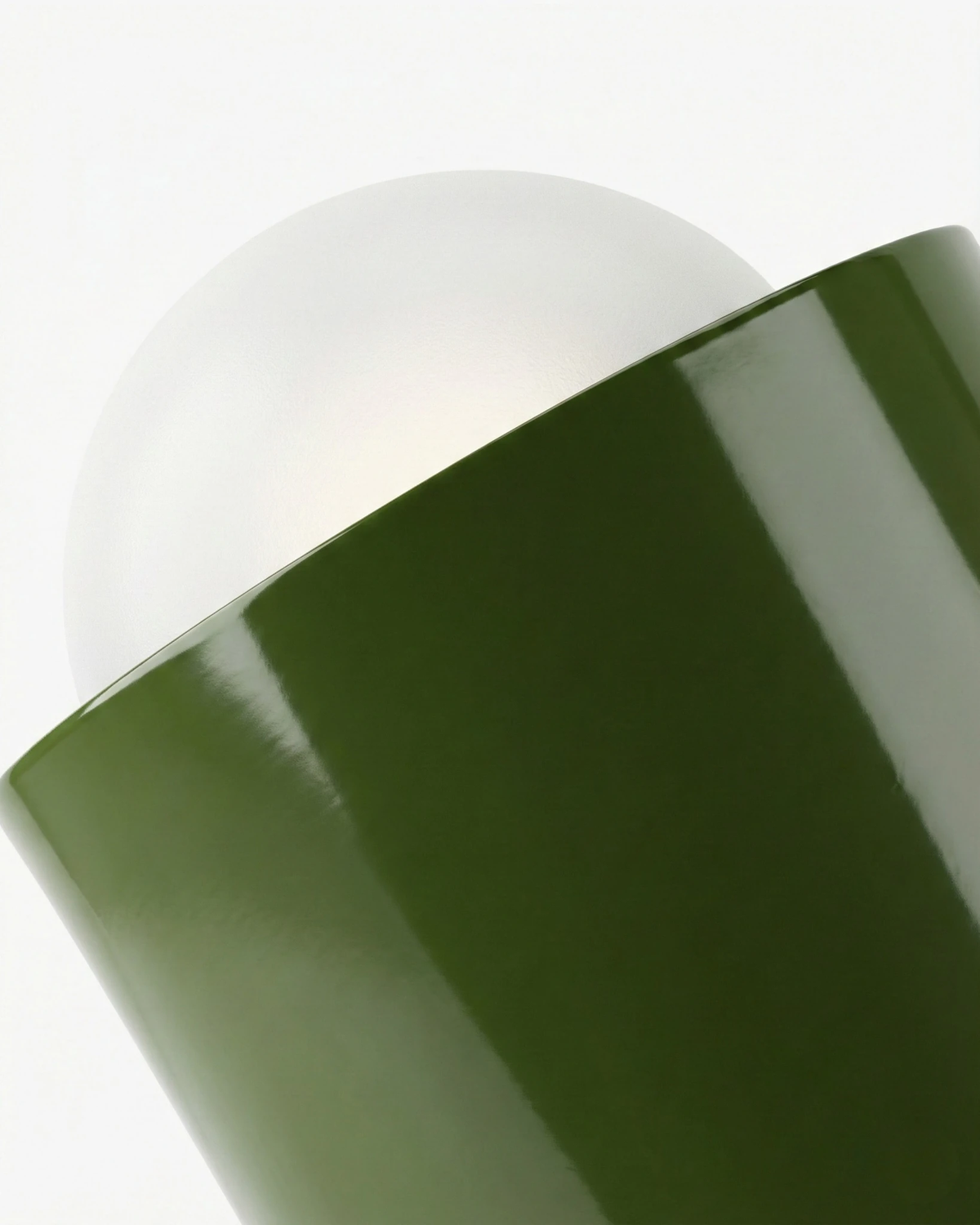 Close-up of the dark green lacquered capsule and frosted bulb of the TORINO No.01 modern wall sconce