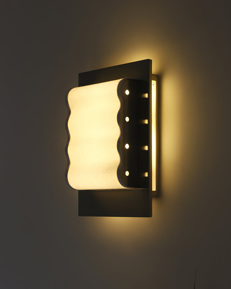 Modern wall sconce MILANO No.01 lit on a dark wall, wavy panel with a row of chrome studs casting light up and down