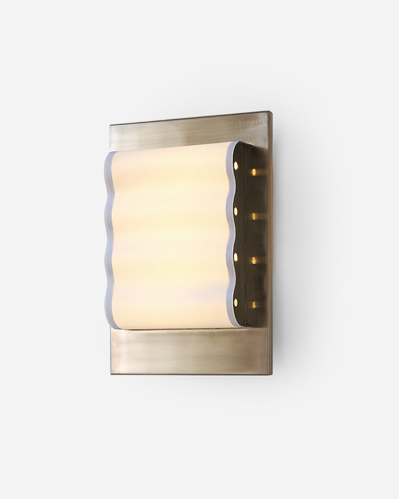 Modern wall sconce MILANO No.01 in Mirror Chrome, wavy acrylic panel lit inside a chrome frame seen at an angle