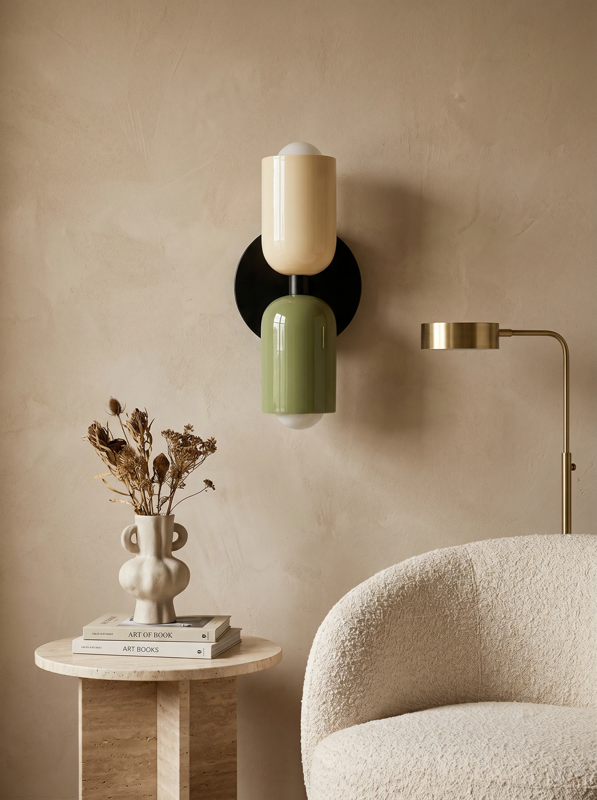 Modern wall sconce TORINO No.01 in beige and green lit on a plaster wall beside a boucle armchair and brass floor lamp