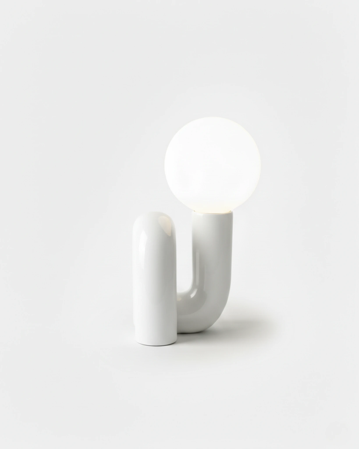 Opal globe table lamp VICO No.01 in Off-White, matte sculpted base with the globe switched on