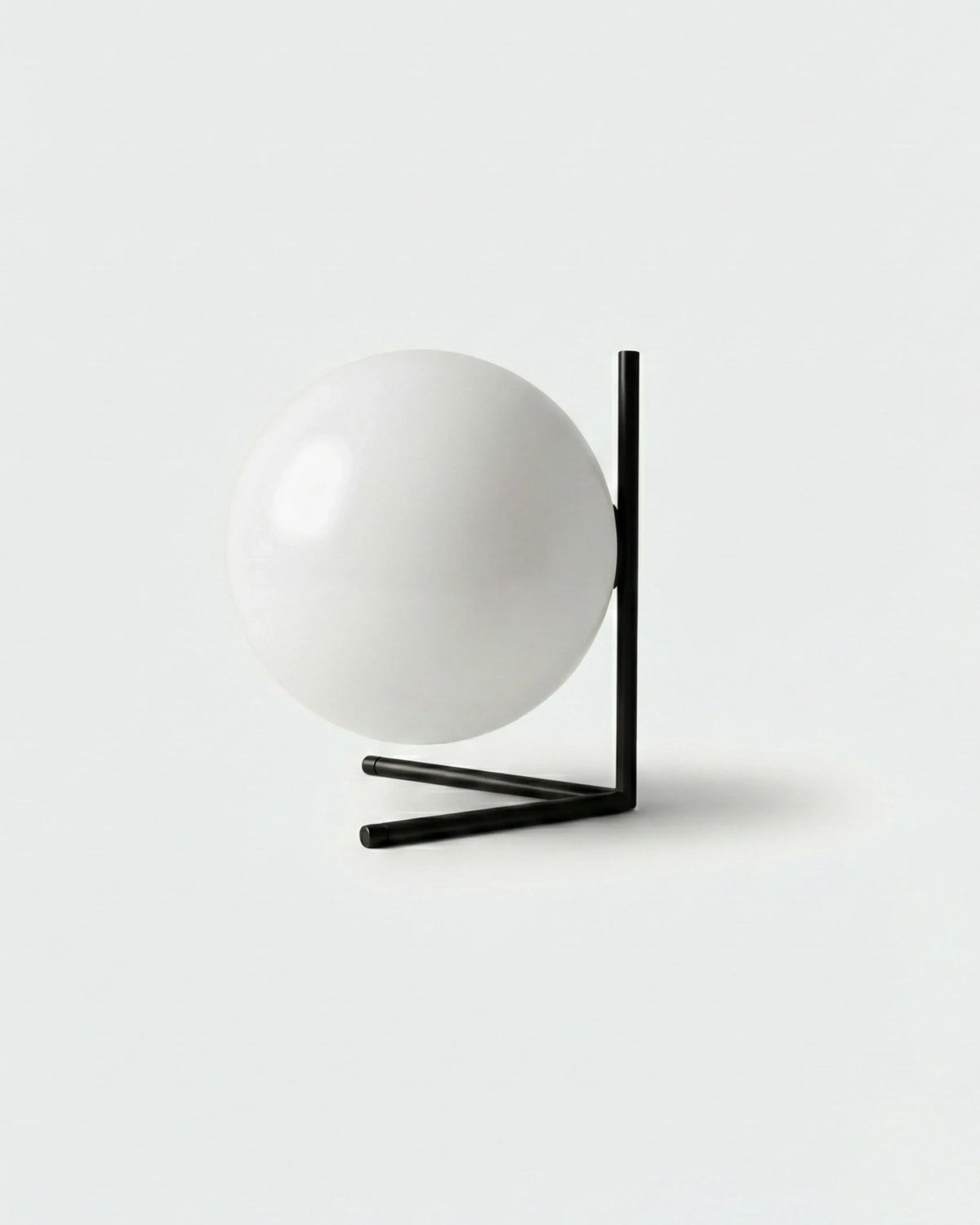 Opal globe table lamp ARIA No.01, white globe suspended on a matte black L-shaped bracket, unlit
