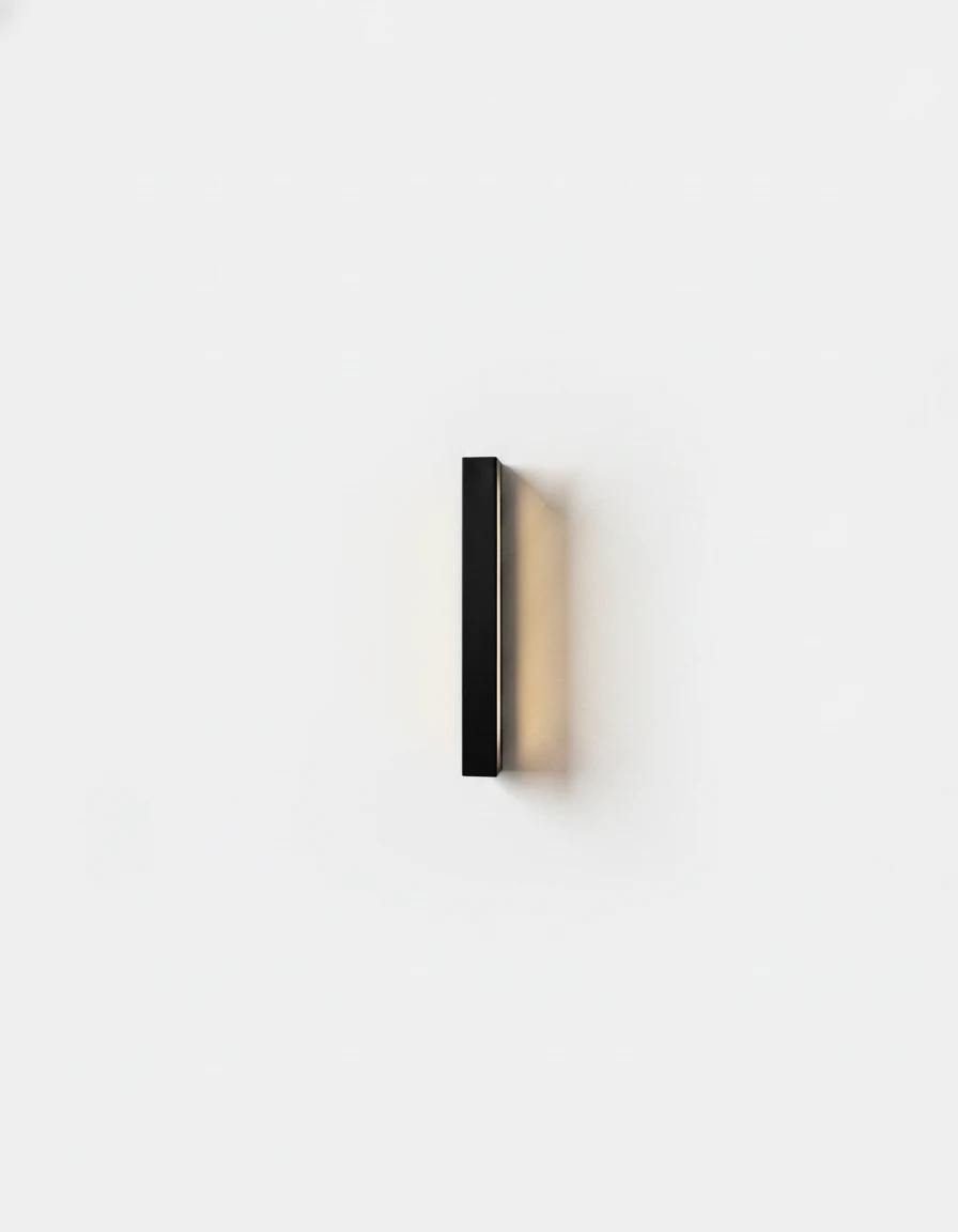 Outdoor wall sconce FRECCIA No.01, compact 30 cm (11.8 in) black LED bar lit on a plain white wall