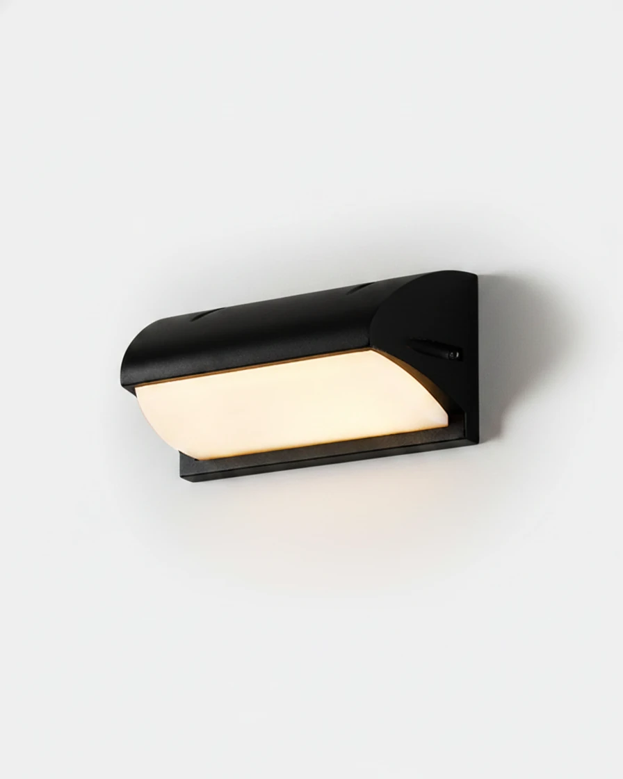 Outdoor wall sconce NOTO No.04 Compact 8 in, black cast aluminum visor over a warm lit diffuser