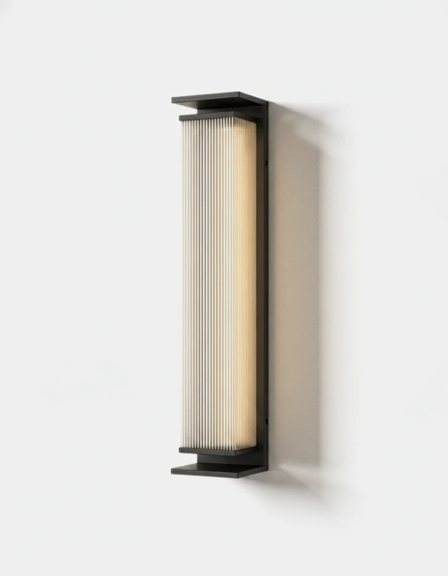 Outdoor wall sconce COSTA No.01 switched on, tall fluted glass column with a black aluminum frame, angled view