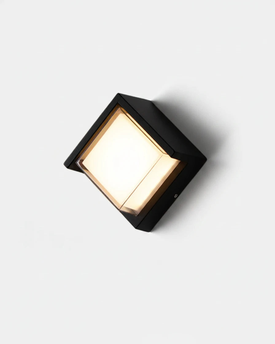 Outdoor wall sconce FARA No.02, black cube with a recessed opal diffuser switched on, angled on white